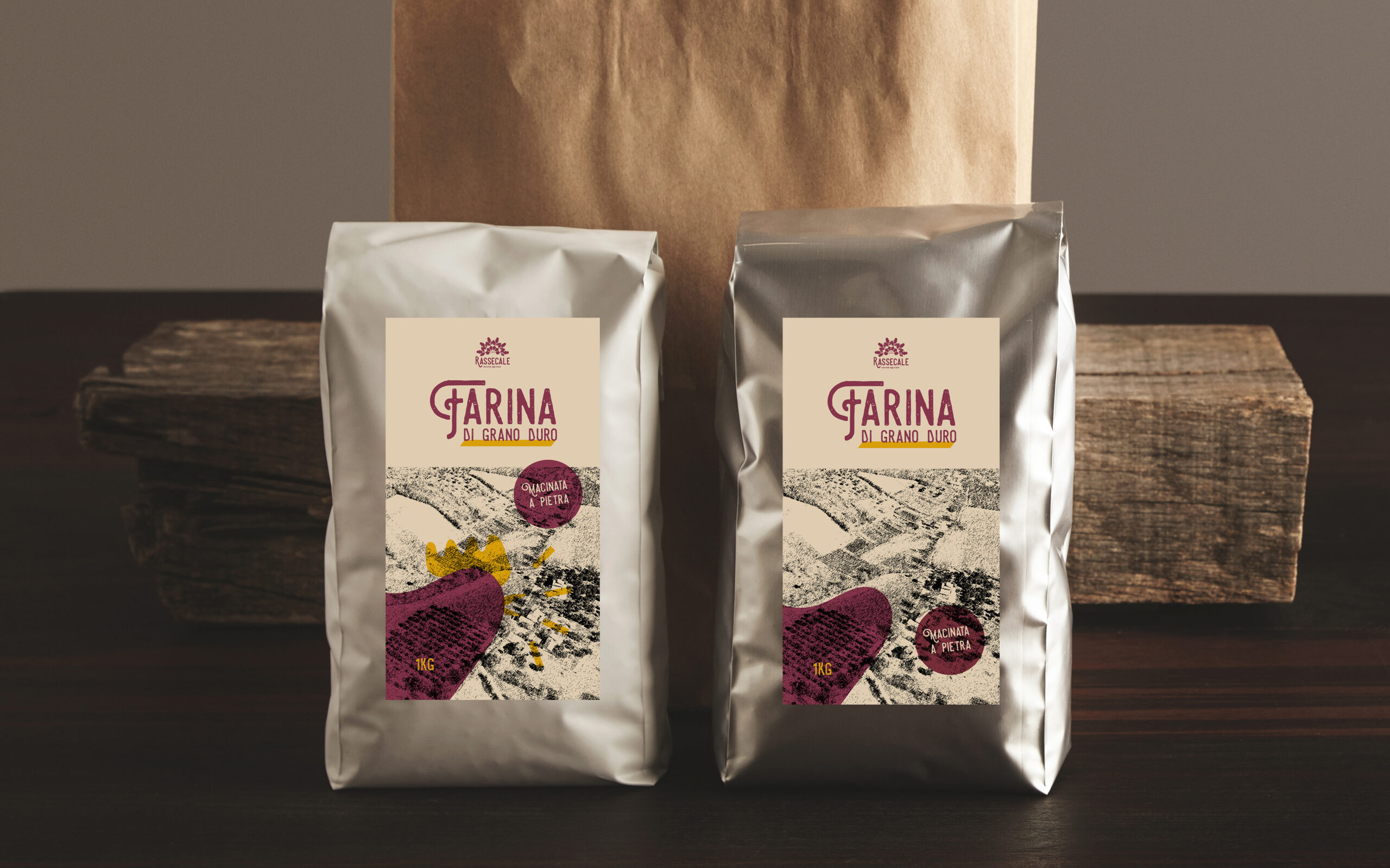 Retailer merchandise pack: Two big hermetic pouches white and si Retailer merchandise pack: Two big hermetic pouches white and silver metallic, with blank labels presented in front of craft paper bag and rustic wooden brick on red table, isolated. Coffee or tea distribution